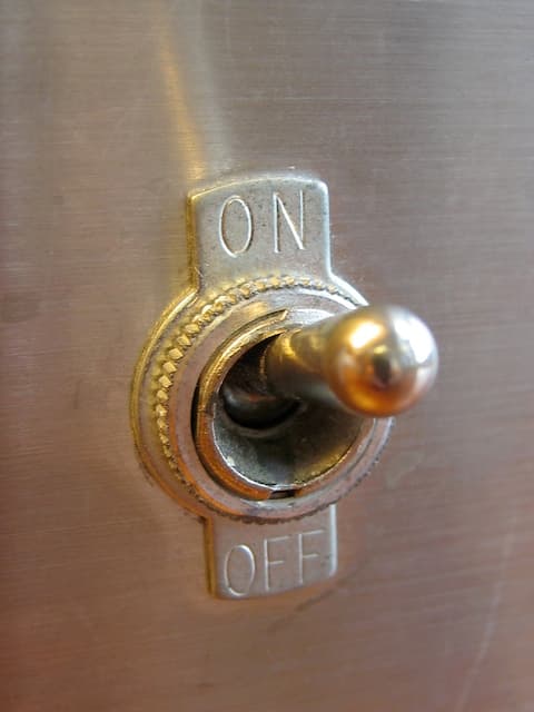 Metal on-off toggle switch mounted in a panel