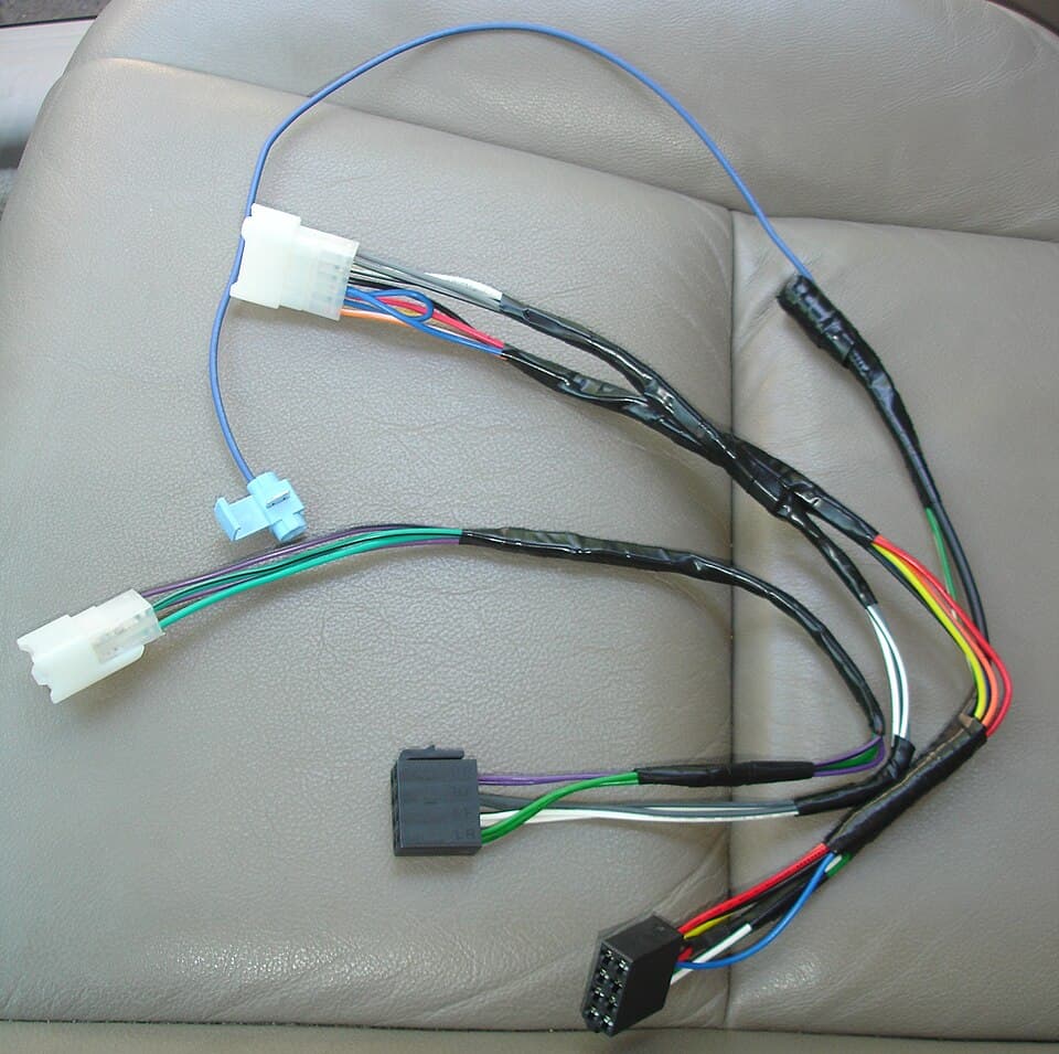 Vehicle wiring harness with coloured cables and plug connectors